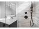 Close up of the bathroom featuring dual sinks and glass-enclosed shower at 1256 Yates St, Denver, CO 80204