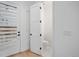 Bright half bathroom with white fixtures and a white door with modern hardware at 1256 Yates St, Denver, CO 80204