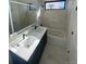 Modern bathroom featuring a double vanity, soaking tub, and stylish fixtures at 1256 Yates St, Denver, CO 80204