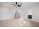 A bright bedroom featuring plush carpeting, modern ceiling fan, and two entry doors at 1256 Yates St, Denver, CO 80204