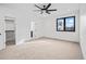Bright bedroom with carpet, walk-in closet, and window with black trim overlooking exterior at 1256 Yates St, Denver, CO 80204