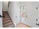 Light-filled foyer featuring a staircase, modern doors, and pristine hardwood flooring at 1256 Yates St, Denver, CO 80204