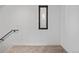 Well lit carpeted hallway with modern design and a modern-styled window at 1256 Yates St, Denver, CO 80204