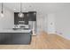 Modern kitchen with stainless steel appliances, island, and stylish cabinetry at 1256 Yates St, Denver, CO 80204