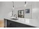 Modern kitchen featuring sleek black cabinets, quartz countertops and stainless steel sink and appliances at 1256 Yates St, Denver, CO 80204