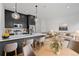 Modern kitchen island with stainless steel appliances, seating, and bright pendant lighting at 1256 Yates St, Denver, CO 80204