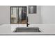 Close up of a modern sink in the kitchen with quartz countertops and matte black faucet at 1256 Yates St, Denver, CO 80204