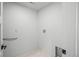 Well-lit laundry room with tile floors and hookups for a washer and dryer at 1256 Yates St, Denver, CO 80204