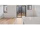Bright living room with hardwood floors and sliding glass doors to an outdoor balcony at 1256 Yates St, Denver, CO 80204