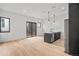 Bright and airy living room featuring hardwood floors and stylish modern kitchen at 1256 Yates St, Denver, CO 80204