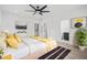 A bright main bedroom featuring artwork, plants, and access to an on-suite bathroom at 1256 Yates St, Denver, CO 80204