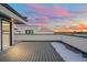 Rooftop deck features composite decking and views of a colorful sunset at 1256 Yates St, Denver, CO 80204