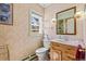 Bathroom featuring a vanity, toilet, and window providing natural light at 7750 W 5Th Ave, Lakewood, CO 80226