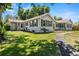 Charming home with green shutters, mature trees, and a well-manicured lawn, perfect for outdoor enjoyment at 7750 W 5Th Ave, Lakewood, CO 80226