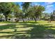 Spacious front yard with mature trees offering shade and curb appeal to this charming home at 7750 W 5Th Ave, Lakewood, CO 80226