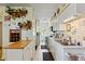 Efficient kitchen featuring white cabinetry and modern appliances, offering a clean and functional cooking space at 7750 W 5Th Ave, Lakewood, CO 80226