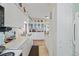 Well-lit kitchen with white cabinets and appliances, providing a clean and organized space for cooking and storage at 7750 W 5Th Ave, Lakewood, CO 80226