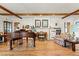 Inviting living room with wood floors, beamed ceiling, and a stone fireplace, perfect for relaxing and entertaining at 7750 W 5Th Ave, Lakewood, CO 80226