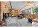 This sun room features a brick fireplace, multiple windows, and access to the outdoors at 7750 W 5Th Ave, Lakewood, CO 80226