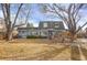 Backyard with spacious deck, mature trees, and lush lawn, perfect for outdoor activities and relaxation at 3241 S Krameria St, Denver, CO 80222
