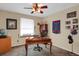 Comfortable bedroom with ceiling fan, desk, sports memorabilia, and natural light at 3241 S Krameria St, Denver, CO 80222
