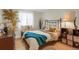 Bright and airy bedroom features warm wood floors, soft lighting, and decorative accents creating a cozy space at 3241 S Krameria St, Denver, CO 80222