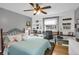 Comfortable bedroom features a built-in desk, shelves, and soft blue accents creating a serene and functional space at 3241 S Krameria St, Denver, CO 80222