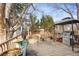 Backyard deck with grill, seating area, and trees offer a perfect space for outdoor enjoyment at 3241 S Krameria St, Denver, CO 80222
