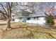 Charming two-story home with light blue exterior, gray roof, and mature trees at 3241 S Krameria St, Denver, CO 80222