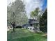 Well-maintained home boasts lush lawn, mature trees, and landscaped garden, enhancing its curb appeal at 3241 S Krameria St, Denver, CO 80222