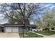 Inviting home exterior featuring a two-car garage and well-manicured lawn at 3241 S Krameria St, Denver, CO 80222