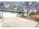 Exterior view of home with two-car garage and concrete driveway at 3241 S Krameria St, Denver, CO 80222
