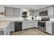 Contemporary kitchen with stainless steel appliances, gray cabinets, and tile floors at 3241 S Krameria St, Denver, CO 80222