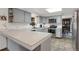 Well-lit kitchen with gray cabinets, a peninsula counter, and modern appliances at 3241 S Krameria St, Denver, CO 80222