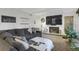 Comfortable living room with gray sectional sofa, fireplace, and large-screen television for cozy relaxation at 3241 S Krameria St, Denver, CO 80222
