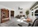 Cozy living room with a ceiling fan, plush carpet, and large windows at 3241 S Krameria St, Denver, CO 80222