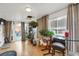 Bright sun room with hardwood floors and glass-top table offers a versatile living space at 3241 S Krameria St, Denver, CO 80222