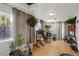 Sunny room with indoor plants, natural light, and wood floors, perfect for relaxing or entertaining at 3241 S Krameria St, Denver, CO 80222