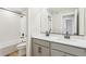 Modern bathroom features double sinks, a large mirror, and a tub/shower combination with sleek, white tiling at 9474 Yampa St, Commerce City, CO 80022