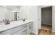 A modern bathroom features a dual sink vanity, quartz countertops, and a glass-enclosed shower with sleek fixtures at 9474 Yampa St, Commerce City, CO 80022