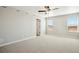 A light and airy bedroom is showcased with neutral walls, plush carpet, and ample natural light from large windows at 9474 Yampa St, Commerce City, CO 80022