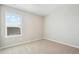 Well-lit bedroom featuring carpet, light walls, a large window with view, and electrical outlets at 9474 Yampa St, Commerce City, CO 80022