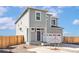 Charming two-story home featuring a covered entry, attached two-car garage and low maintenance yard at 9474 Yampa St, Commerce City, CO 80022