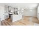 Bright, open kitchen with stainless steel appliances, gray cabinetry, and a large island overlooking the living area at 9474 Yampa St, Commerce City, CO 80022