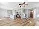 A spacious open-concept living area boasts modern finishes, natural light, and seamless flow with the kitchen and dining spaces at 9474 Yampa St, Commerce City, CO 80022