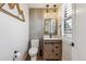 Stylish powder room with wood-look tile accent wall and modern fixtures at 5423 S Prince St # B, Littleton, CO 80120