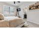Comfortable bedroom with plush carpeting, a large window and a view into the bathroom at 5423 S Prince St # B, Littleton, CO 80120