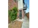 Charming townhome entrance with wreath, stone accent, and a covered walkway at 5423 S Prince St # B, Littleton, CO 80120