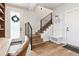 Bright entryway features stairs with black railings, a coat rack, and a door with a decorative wreath at 5423 S Prince St # B, Littleton, CO 80120
