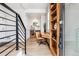 Inviting entryway with a staircase, built-in desk, and modern decor accents at 5423 S Prince St # B, Littleton, CO 80120